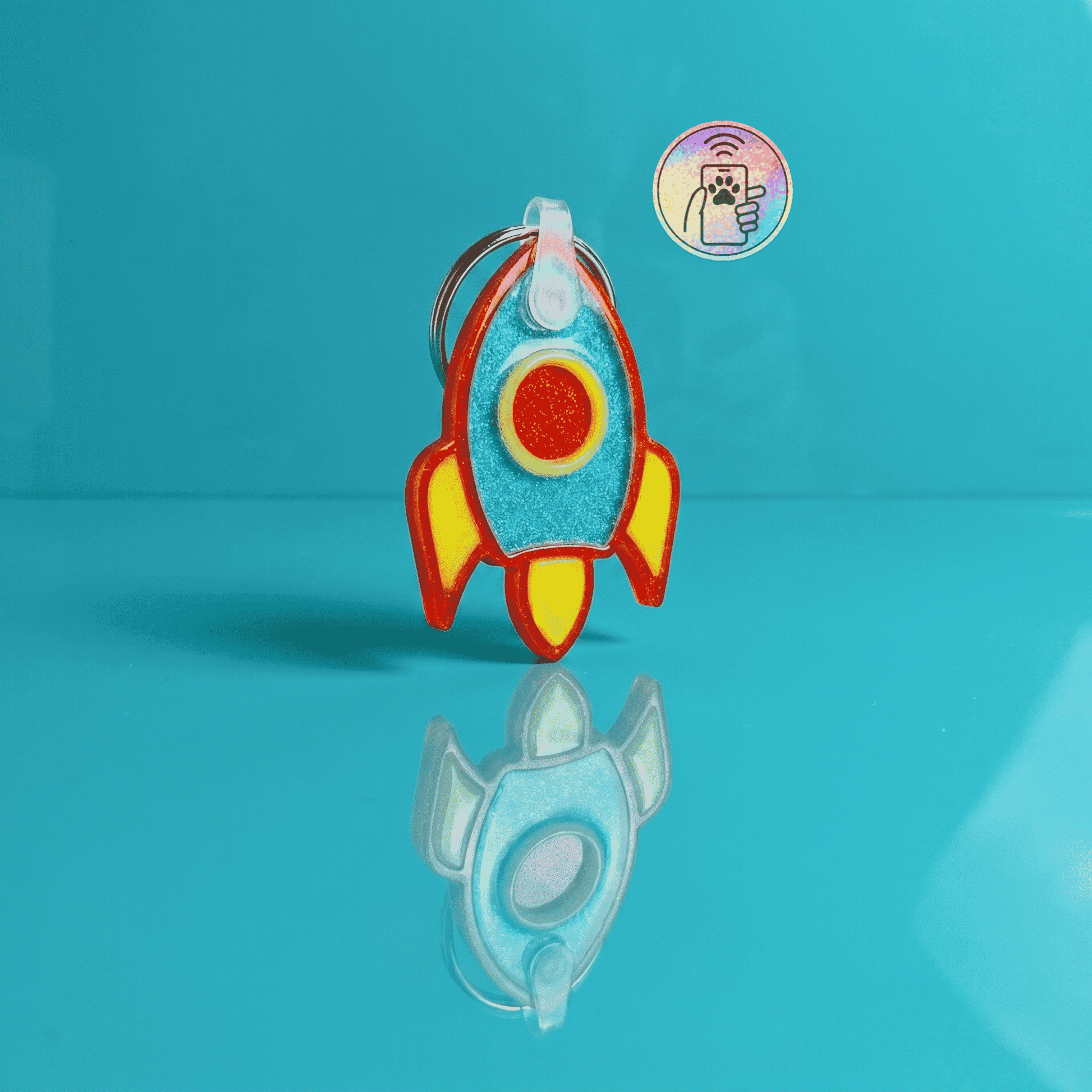 NFC pet ID tag shaped like a rocket, perfect for dogs and cats, with vibrant colors and a keyring at — Shiloh's House smart NFC pet tag with free companion Lohji app.