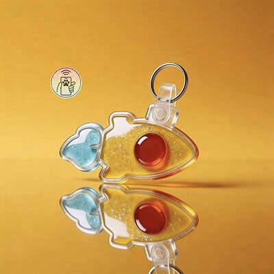 Clear fish-shaped NFC pet ID tag with red and blue details, designed for dogs and cats.