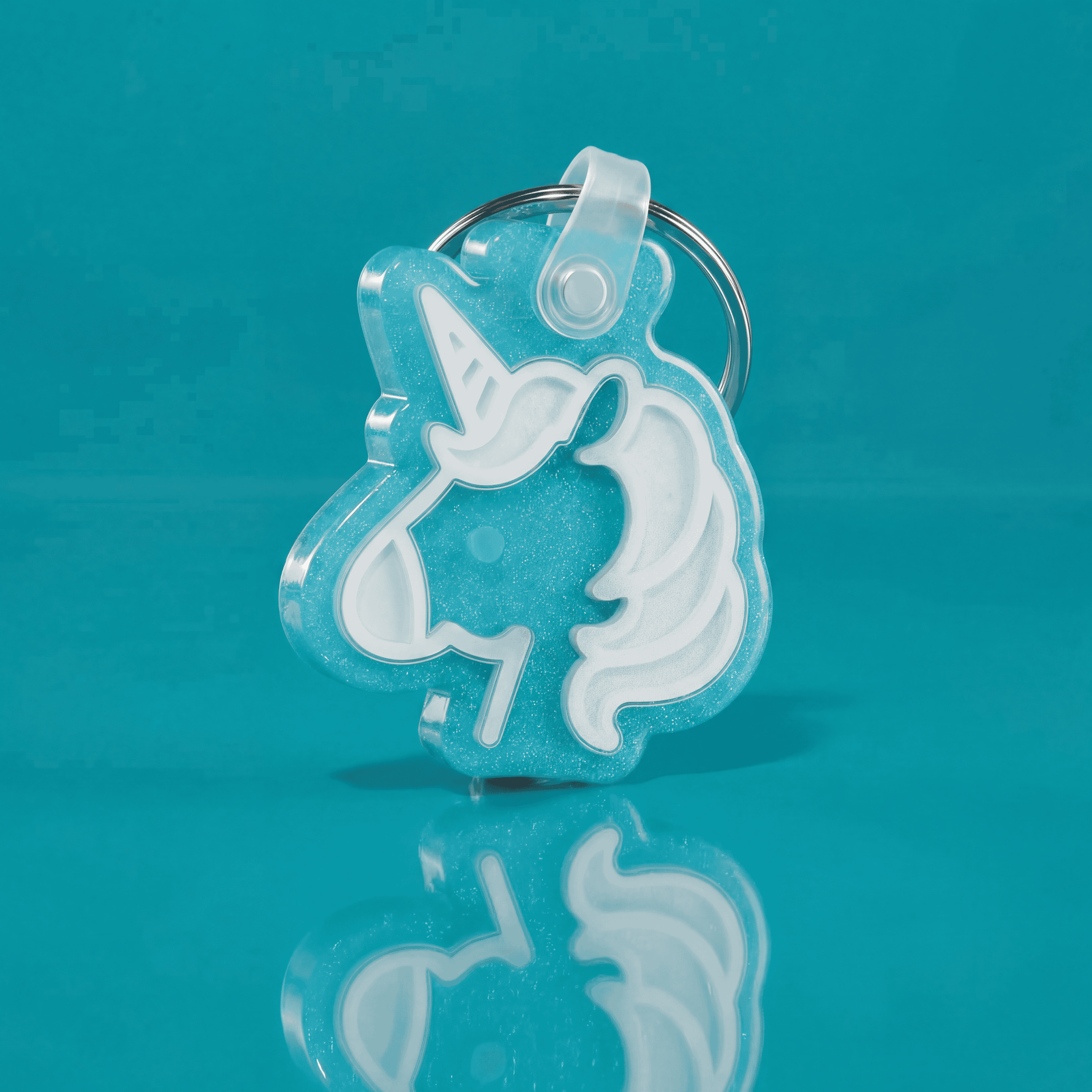 Blue unicorn-shaped NFC pet ID tag in acrylic with white outline for pets.