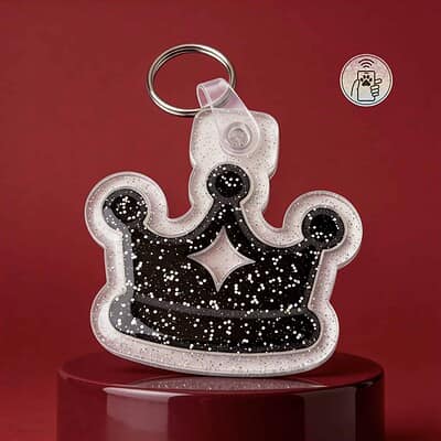 Glittery crown-shaped NFC pet ID tag for dogs and cats with keyring attachment.