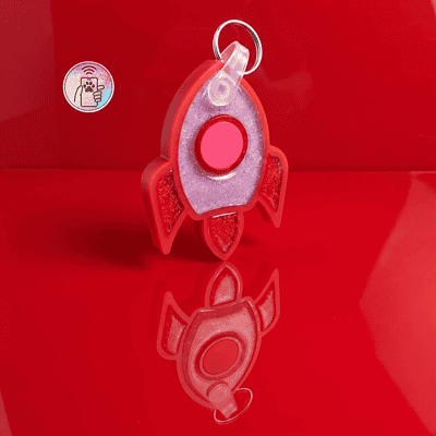 NFC pet ID tag shaped like a rocket in red and pink acrylic for dogs and cats — Shiloh's House smart NFC pet tag with free companion Lohji app.
