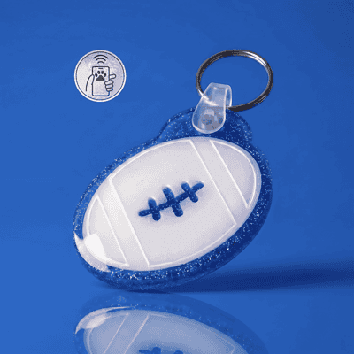 NFC pet ID tag shaped like a football with a blue fishbone design, perfect for dogs and cats — Shiloh's House smart NFC pet tag with free companion Lohji app.