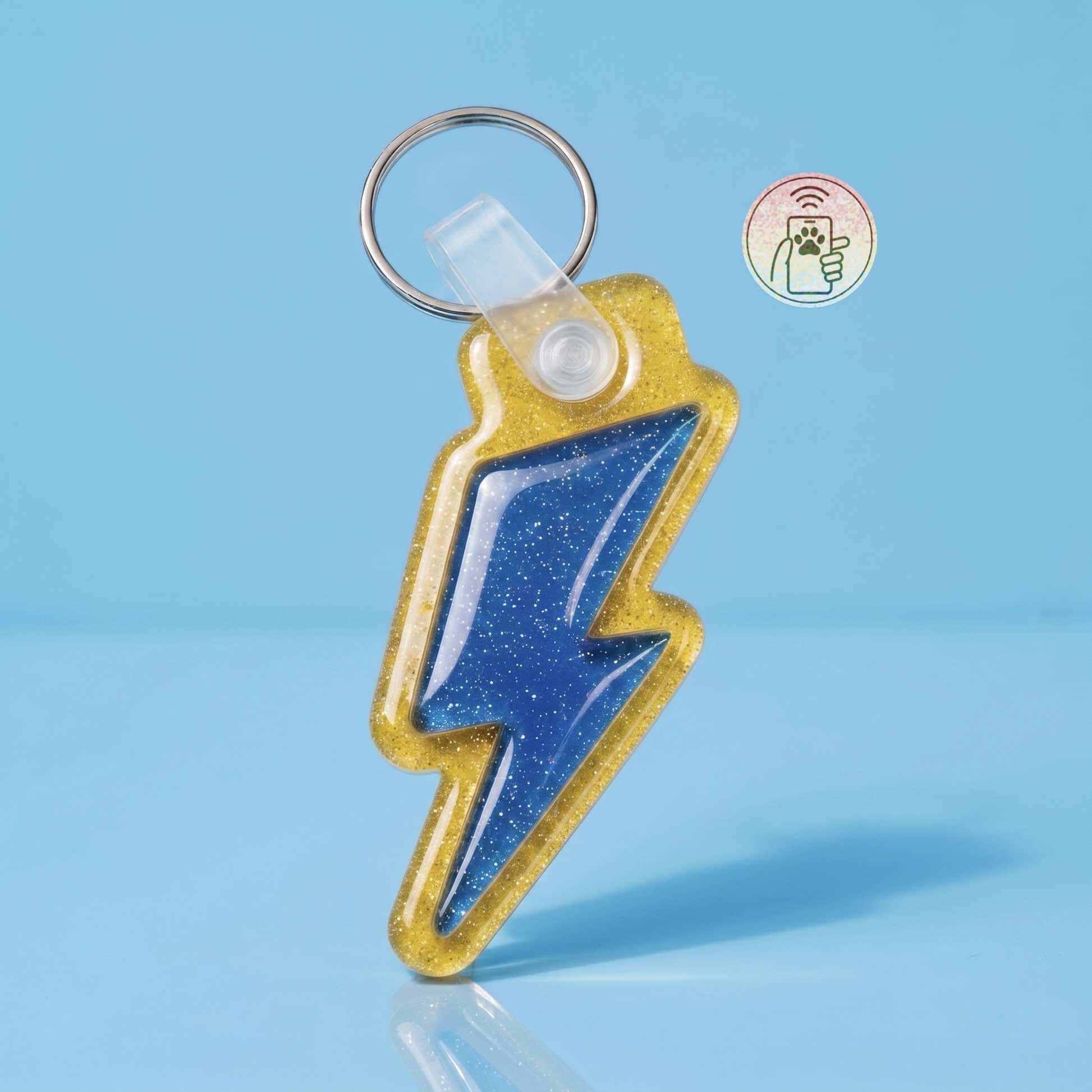 NFC pet ID tag shaped like a lightning bolt with glittery gold and blue colors — Shiloh's House smart NFC pet tag with free companion Lohji app.