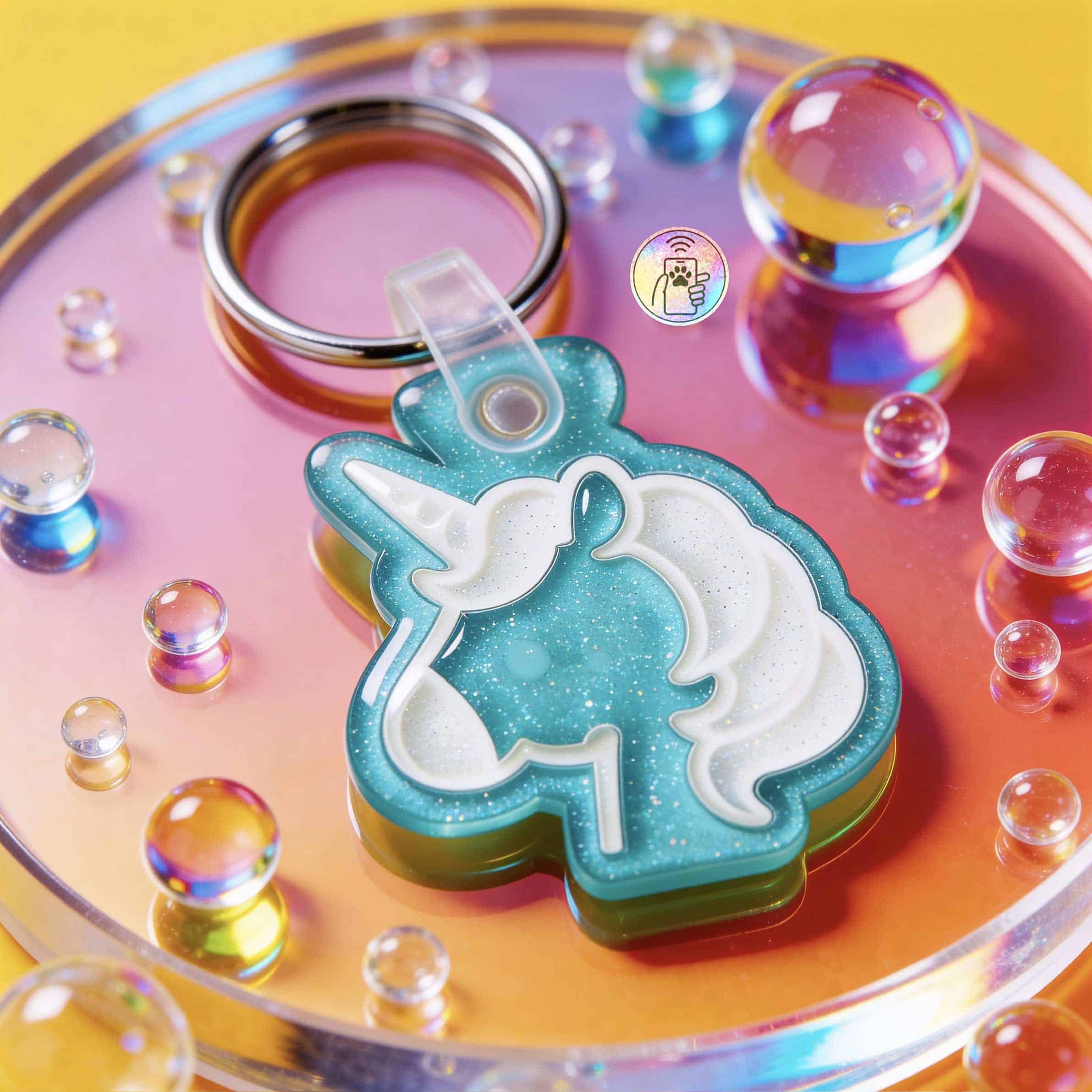 Unicorn-shaped NFC pet ID tag in turquoise with white mane for dogs and cats — Shiloh's House smart NFC pet tag with free companion Lohji app.