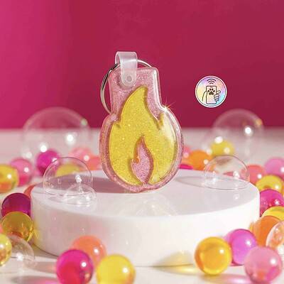 NFC pet ID tag shaped like a flame, perfect for dogs and cats, with a pink glitter background — Shiloh's House smart NFC pet tag with free companion Lohji app.