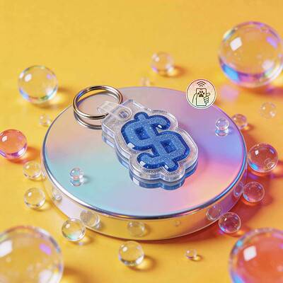 NFC pet ID tag shaped like a dollar sign, designed for dogs and cats, with a blue glitter finish — Shiloh's House smart NFC pet tag with free companion Lohji app.