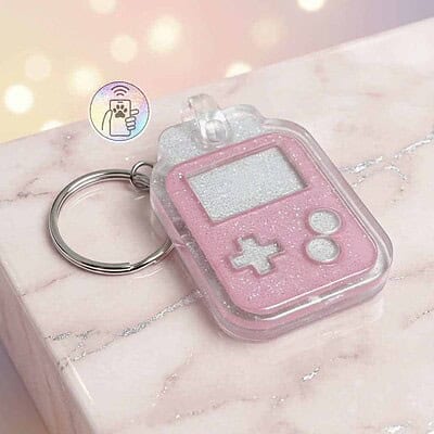 NFC pet ID tag shaped like a game controller in pink with glitter, designed for dogs and cats — Shiloh's House smart NFC pet tag with free companion Lohji app.