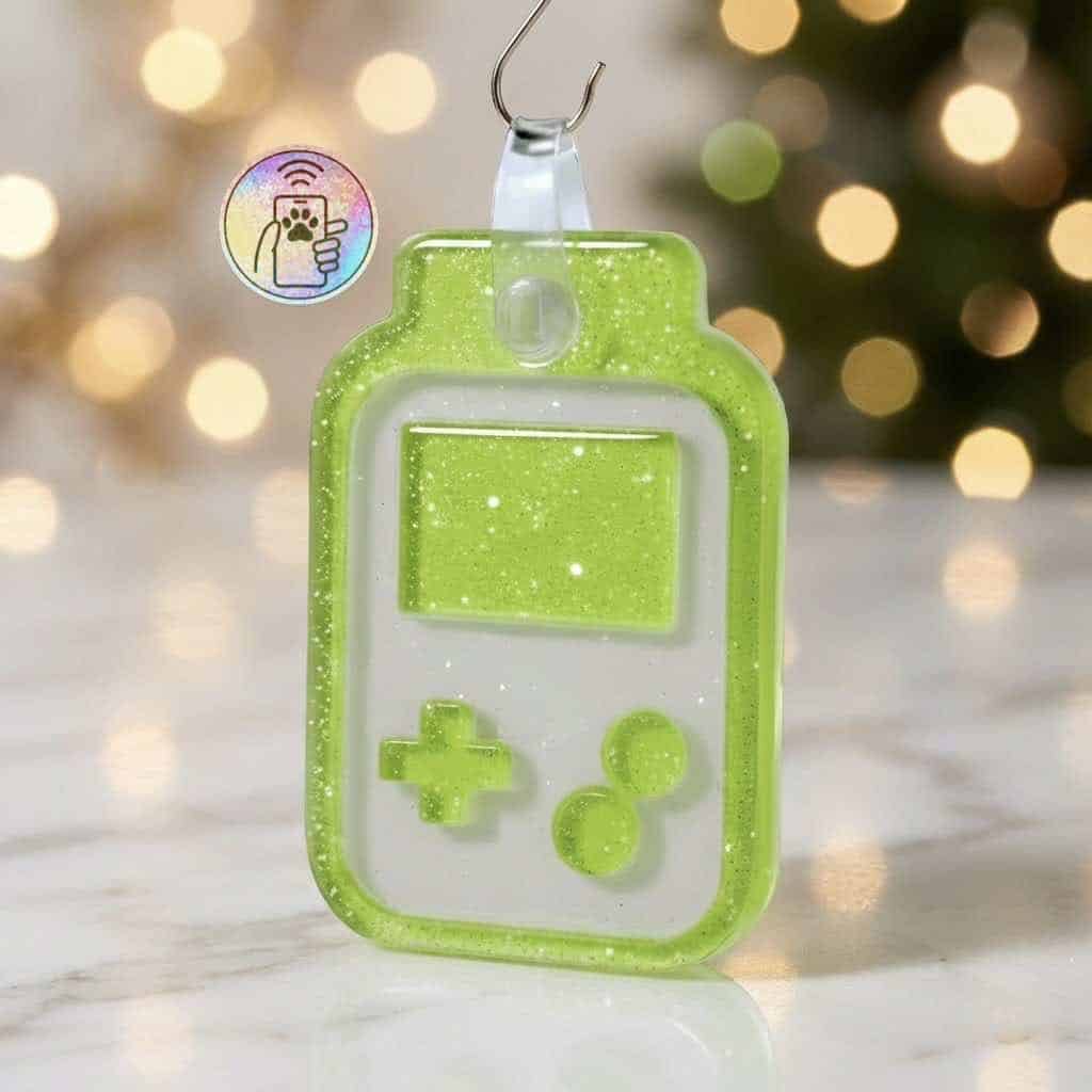 NFC pet ID tag shaped like a game controller in bright green acrylic with white accents.