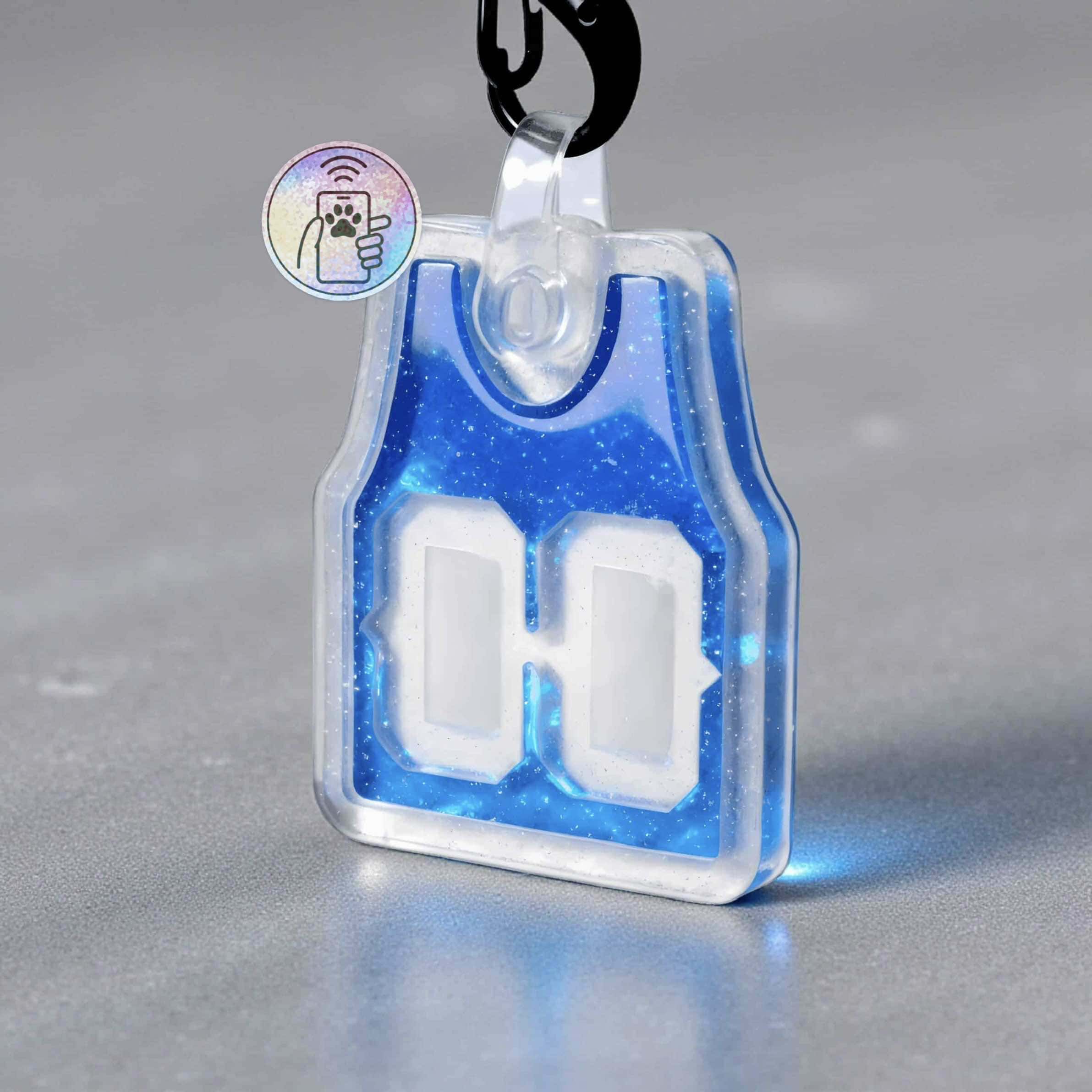 NFC pet ID tag with digital display for dogs and cats, featuring a blue glitter design and a QR code.