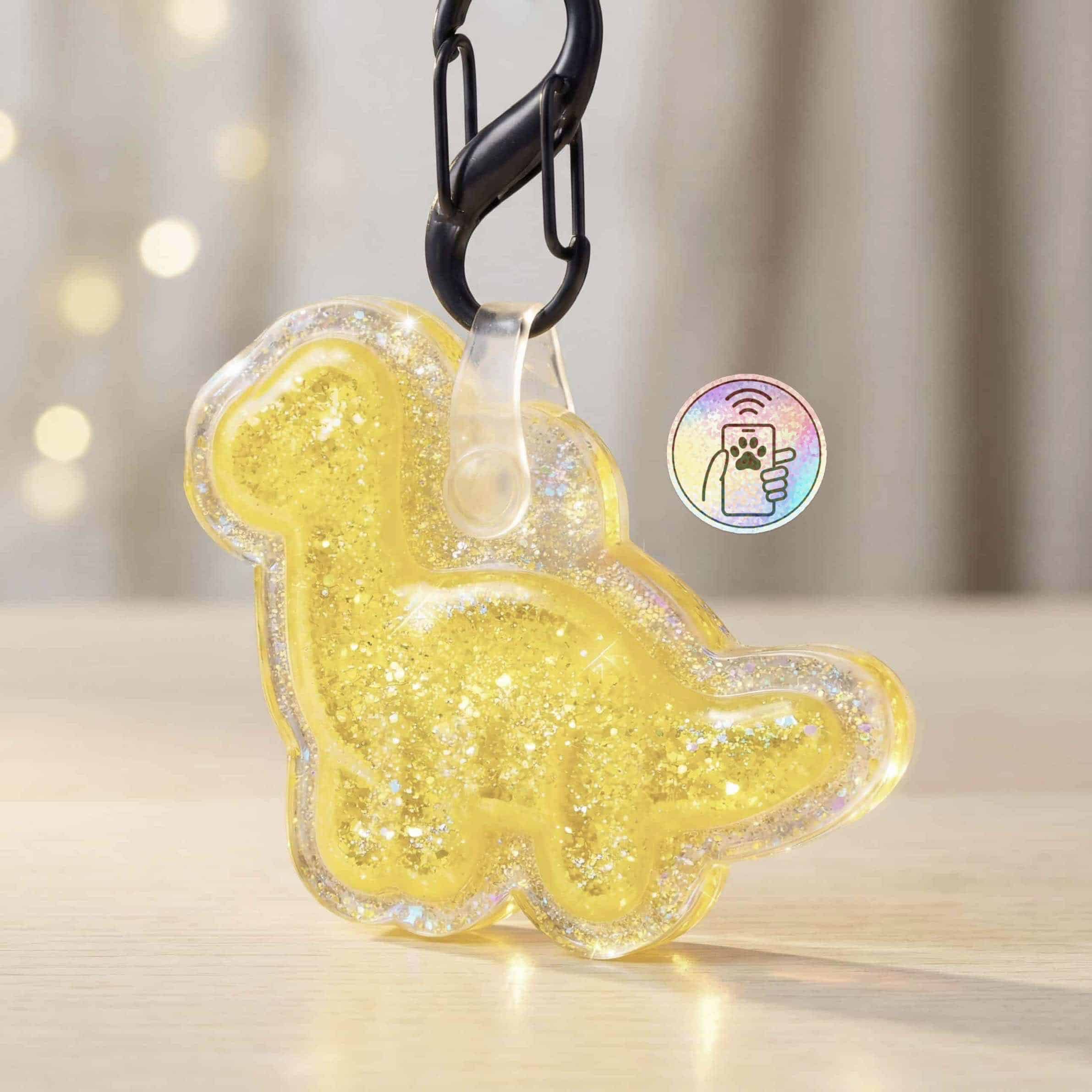 Bright yellow glow-in-the-dark pet ID tag in dinosaur shape with glitter, for dogs and cats.
