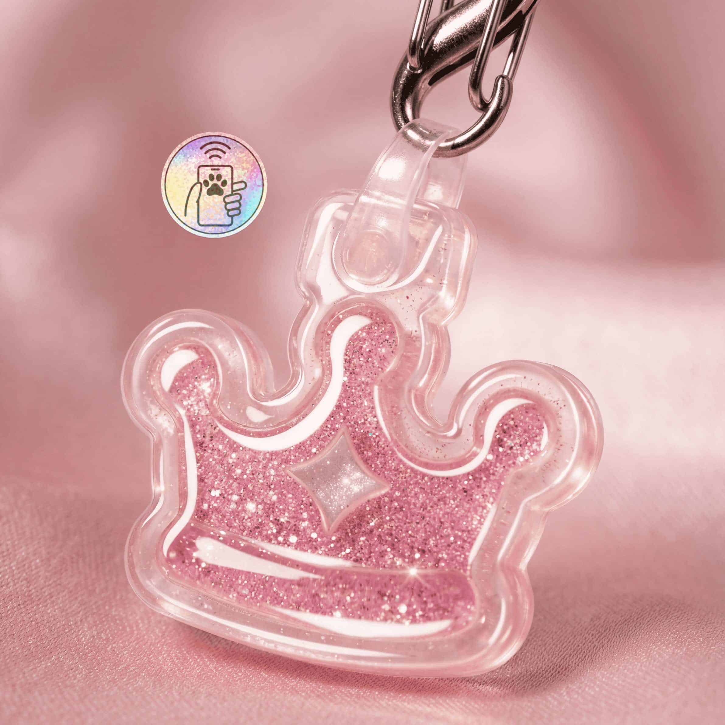 Pink acrylic crown-shaped NFC pet ID tag with glitter accents for dogs and cats.