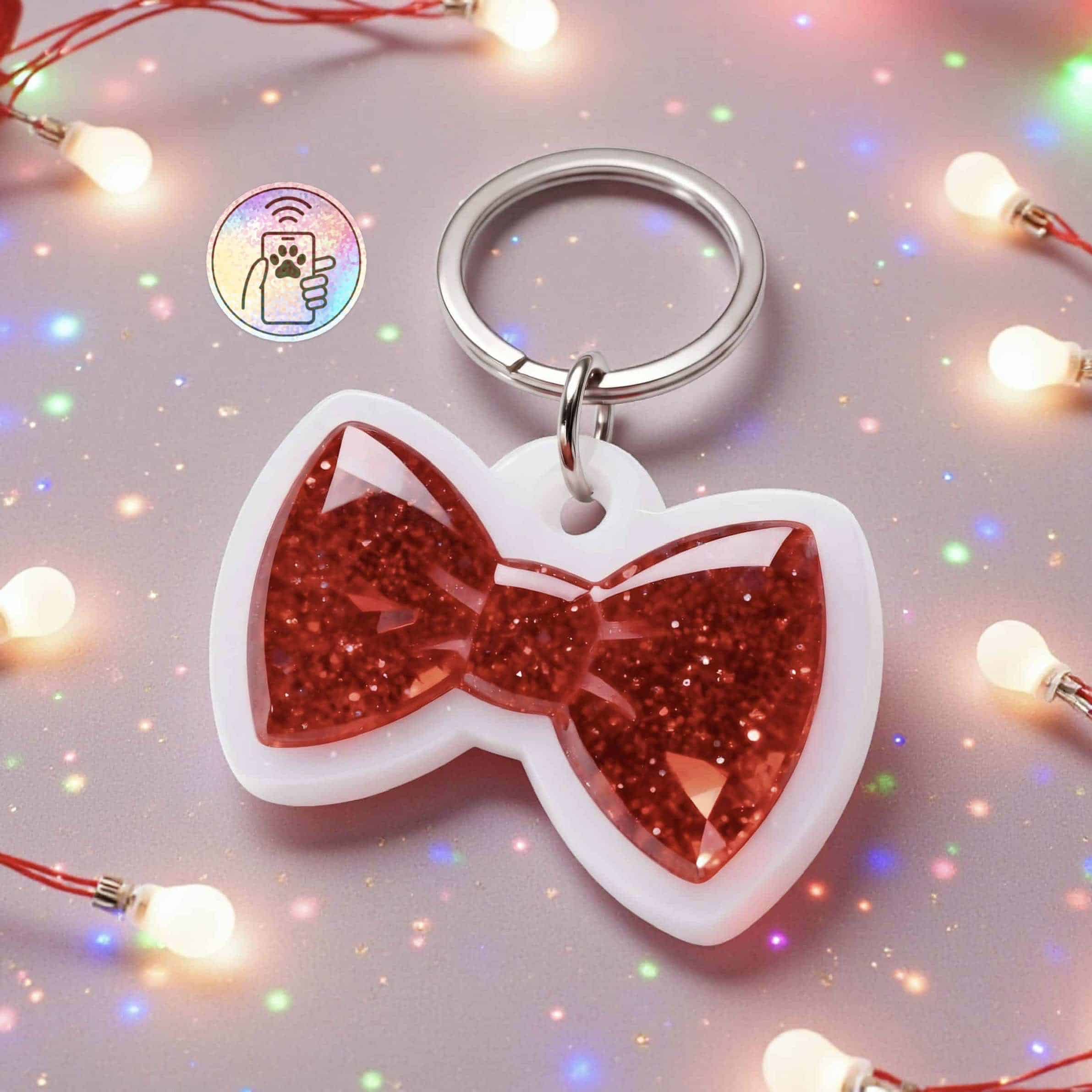 Red glitter bow-shaped NFC pet ID tag for dogs and cats with keyring attachment.
