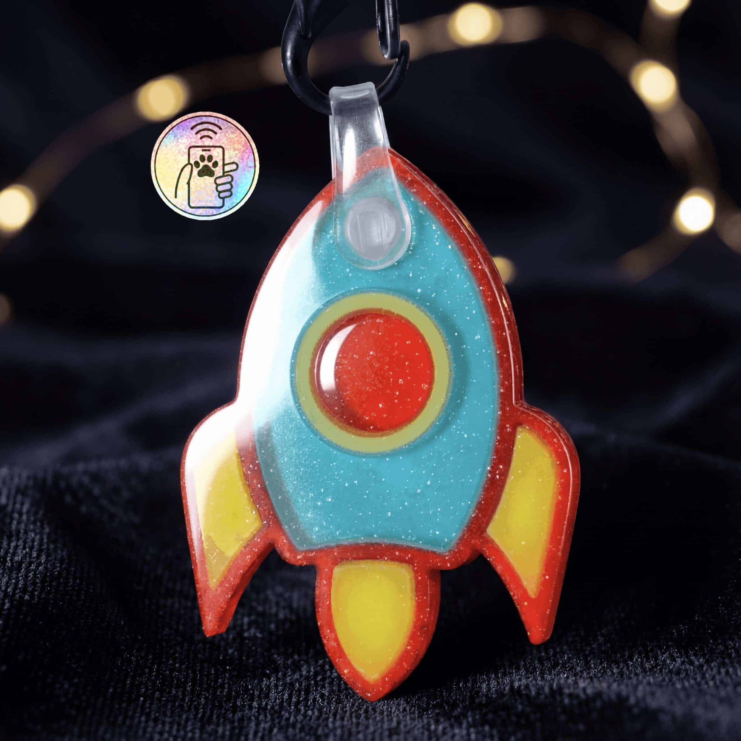 NFC pet ID tag in the shape of a vibrant rocket, perfect for dogs and cats.