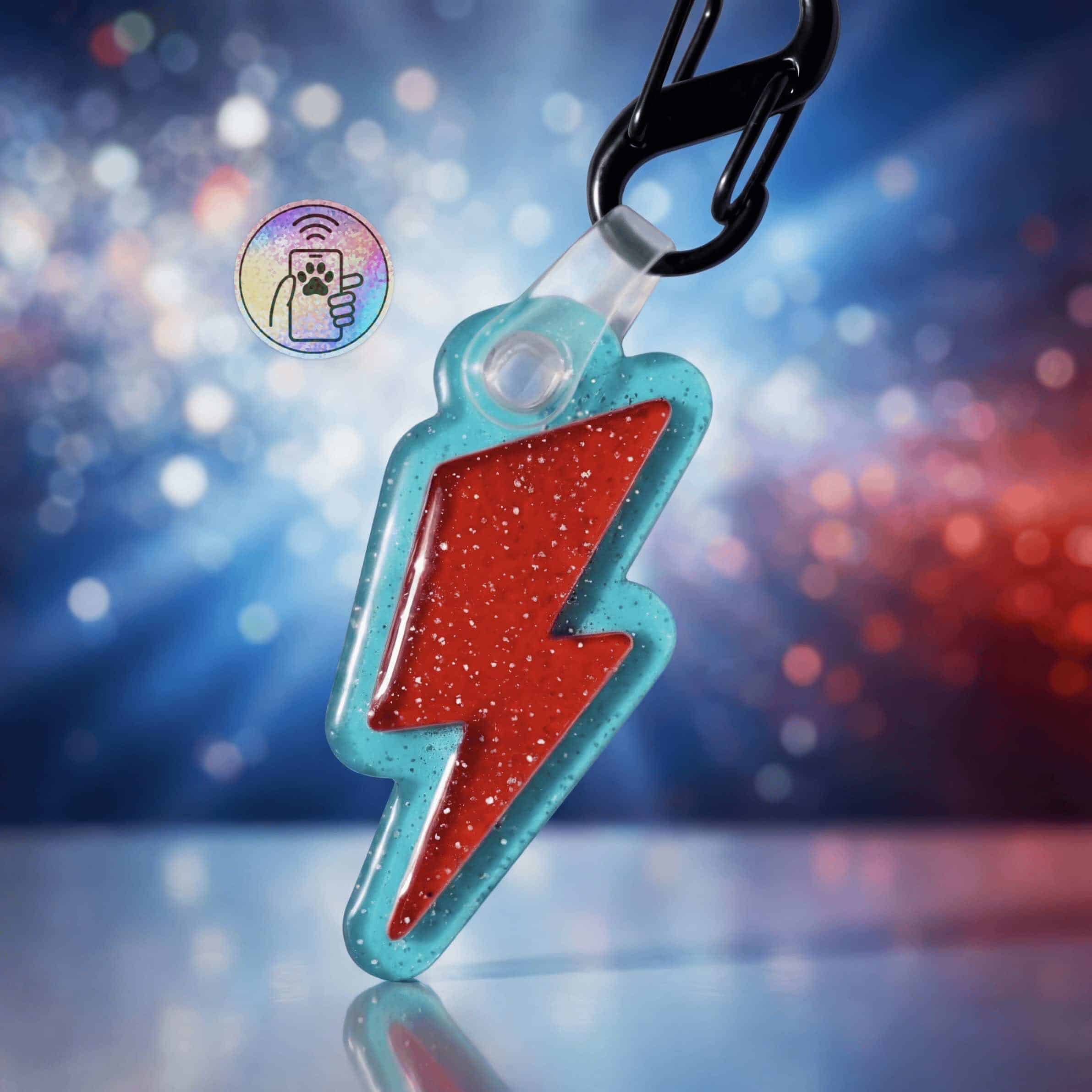 Bright blue acrylic lightning bolt-shaped NFC pet ID tag with red glitter interior, attached to a bl.