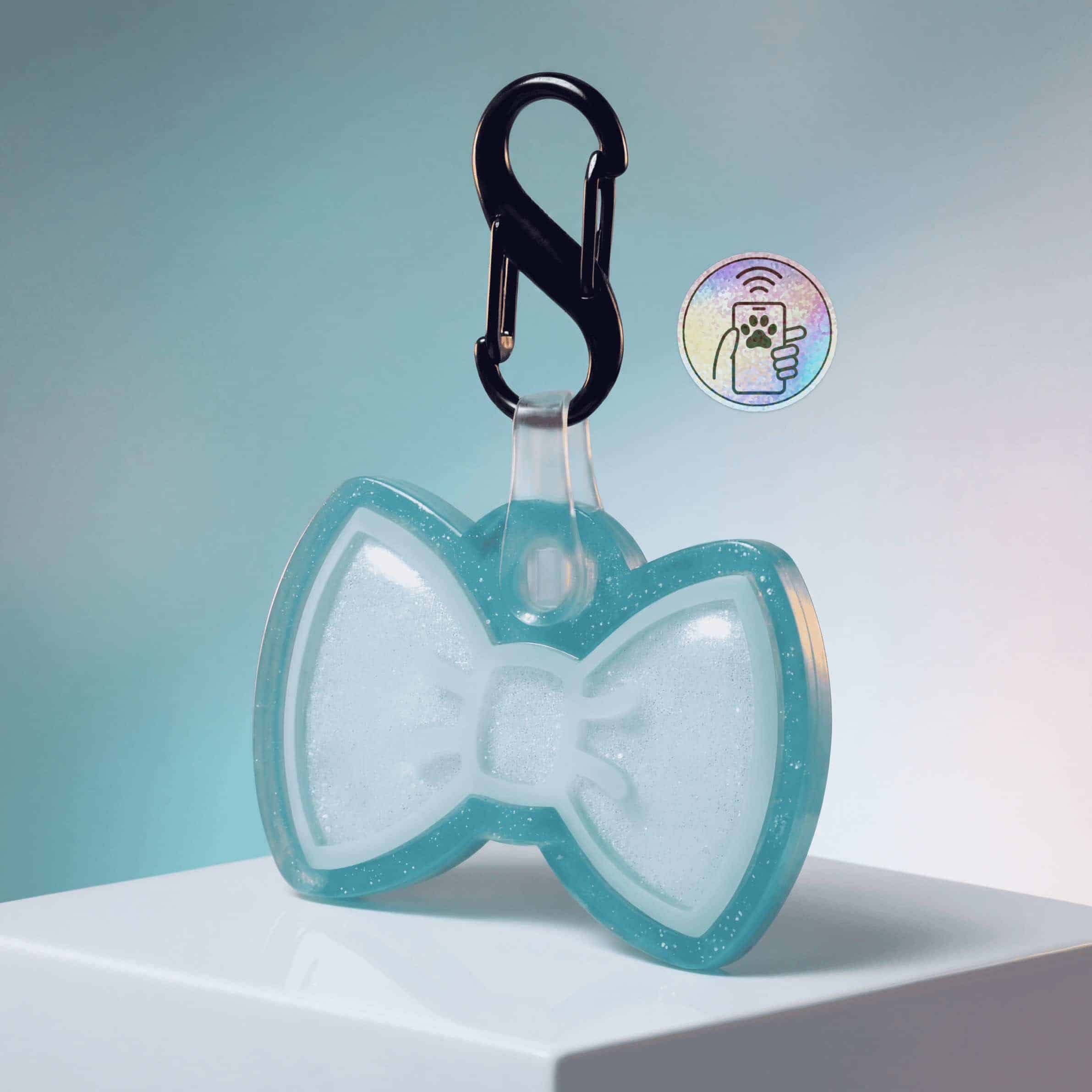 NFC pet ID tag shaped like a bowtie with a black clip for dogs and cats.