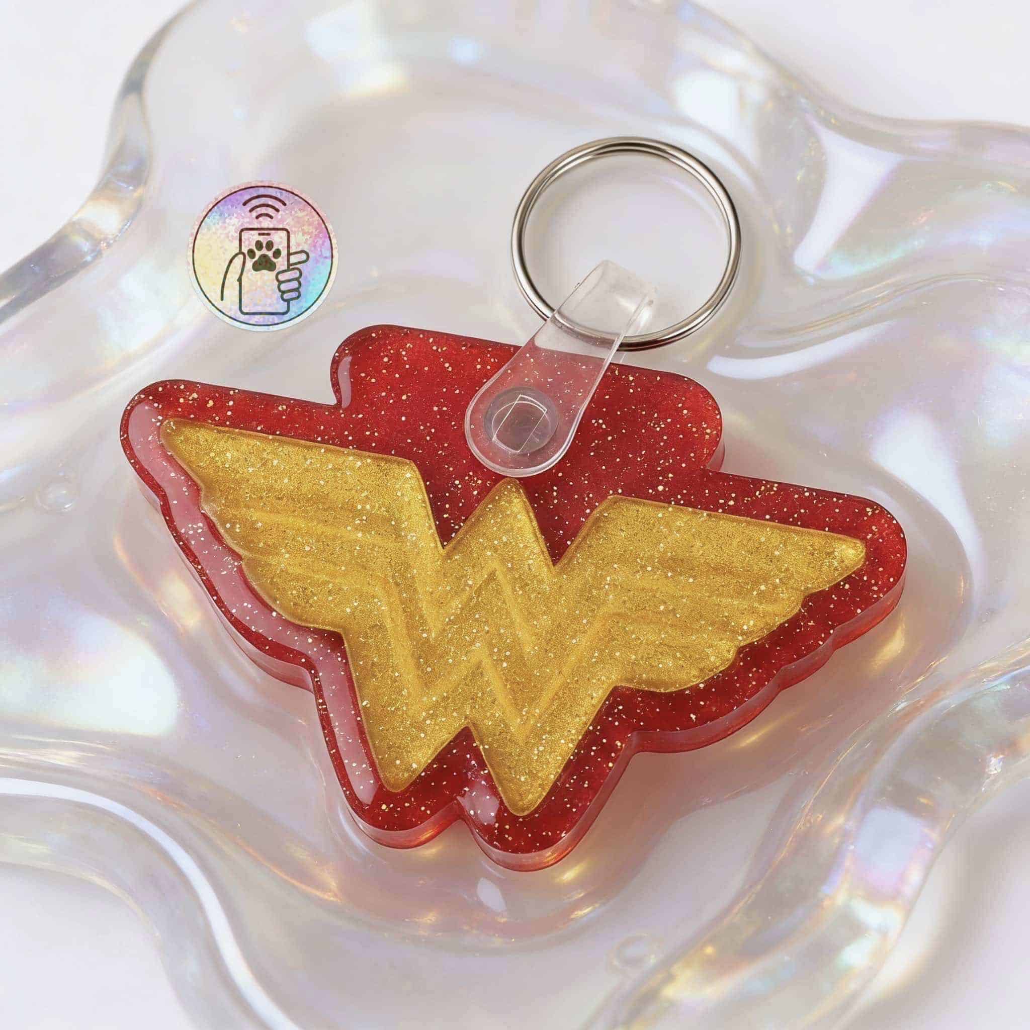 Wonder Woman logo NFC pet ID tag for dogs and cats, featuring a red and gold glitter design.