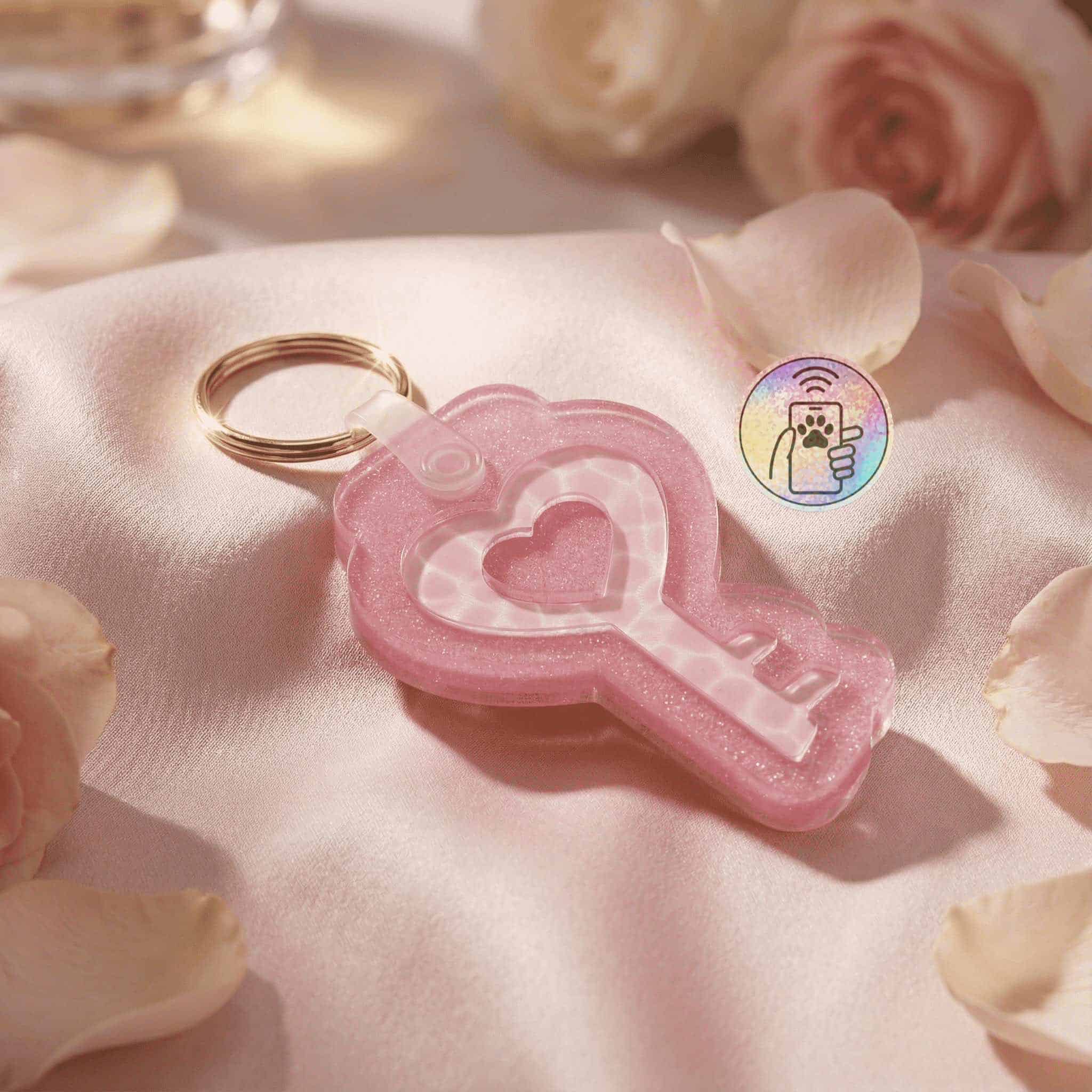 NFC pet ID tag in pink heart shape with keyring, designed for dogs and cats, on satin with roses.