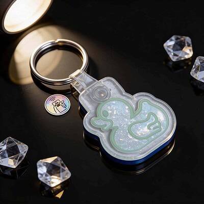 Clear acrylic NFC pet ID tag in a cute dinosaur shape with keychain, sparkly design — Shiloh's House smart NFC pet tag with free companion Lohji app.