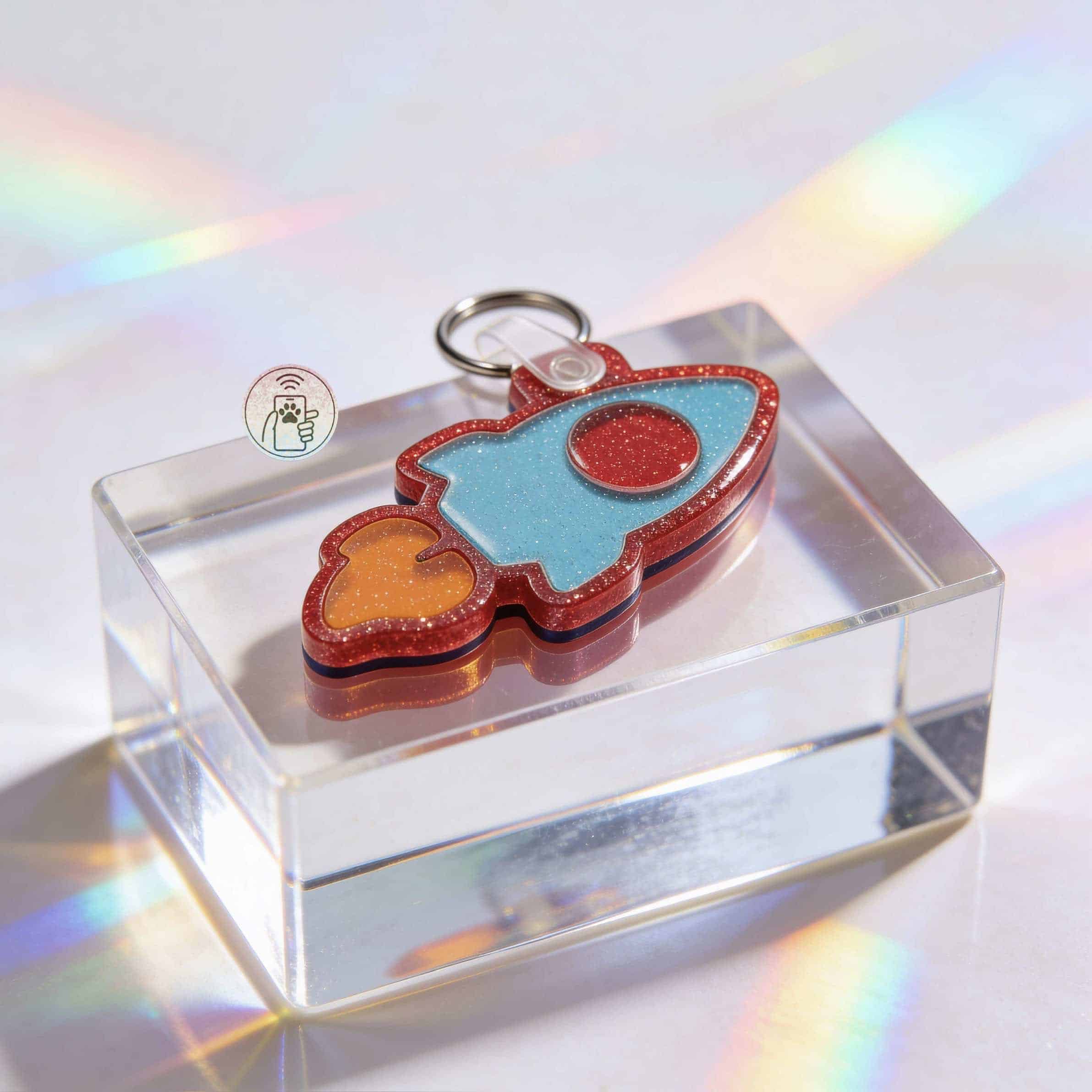 NFC pet ID tag shaped like a rocket in vibrant acrylic, perfect for dogs and cats — Shiloh's House smart NFC pet tag with free companion Lohji app.
