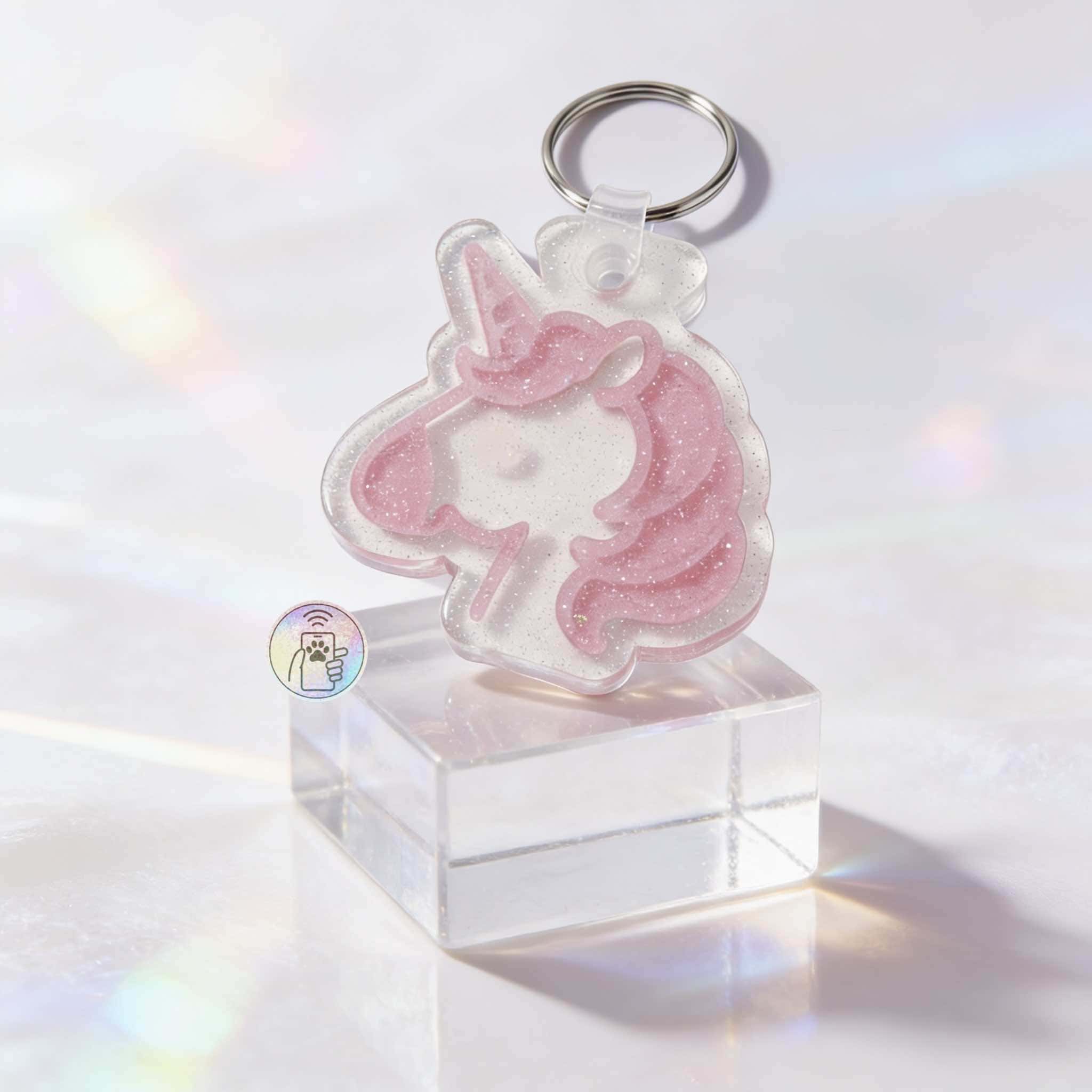 Unicorn-shaped NFC pet ID tag with pink glitter, designed for dogs and cats, attached to a keyring — Shiloh's House smart NFC pet tag with free companion Lohji app.