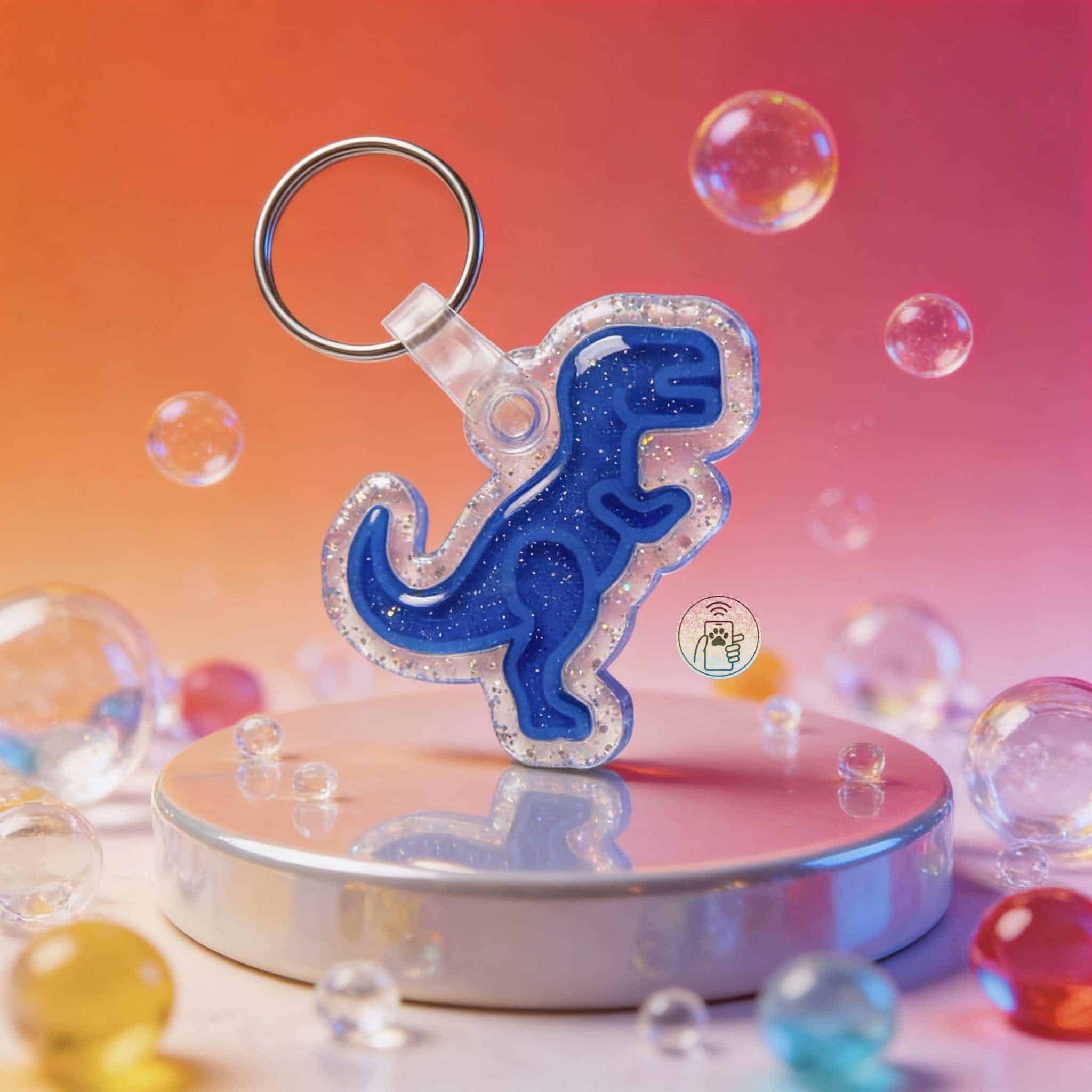 Blue dinosaur-shaped NFC pet ID tag with glitter accents for dogs and cats — Shiloh's House smart NFC pet tag with free companion Lohji app.