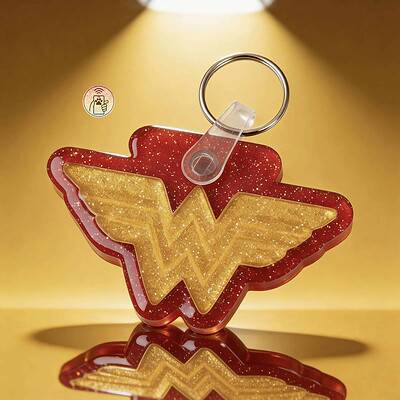NFC pet ID tag shaped like Wonder Woman logo in red and gold with glitter finish. Perfect for dogs a.