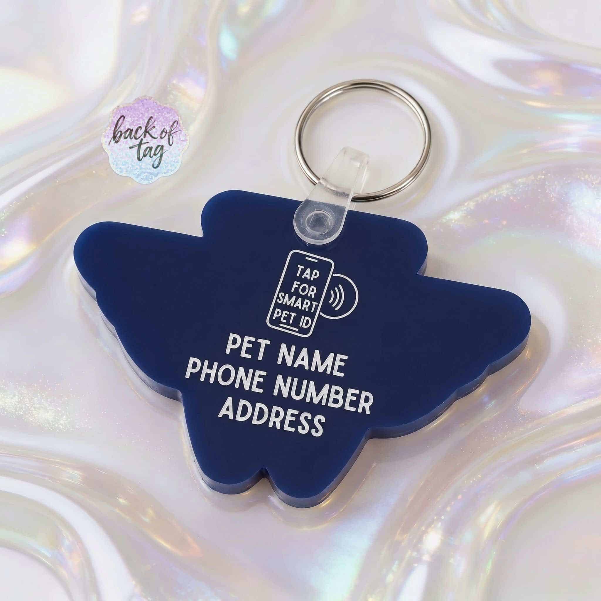 Custom NFC pet ID tag in blue with space for pet name, phone, and address, featuring a QR code for q.