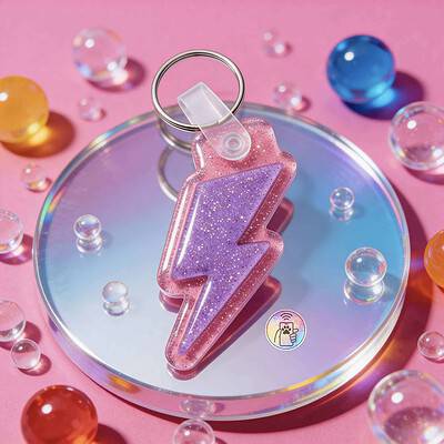 NFC pet ID tag shaped like a lightning bolt with pink glitter, designed for dogs and cats — Shiloh's House smart NFC pet tag with free companion Lohji app.
