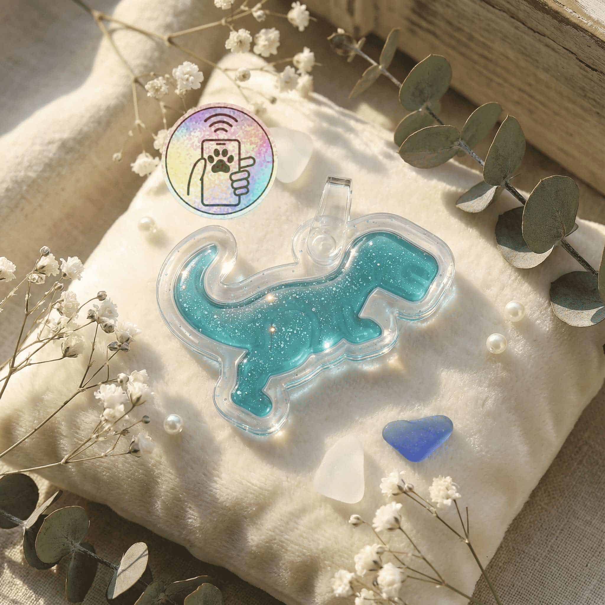 NFC pet ID tag shaped like a dog in blue glitter acrylic with a clear backing.