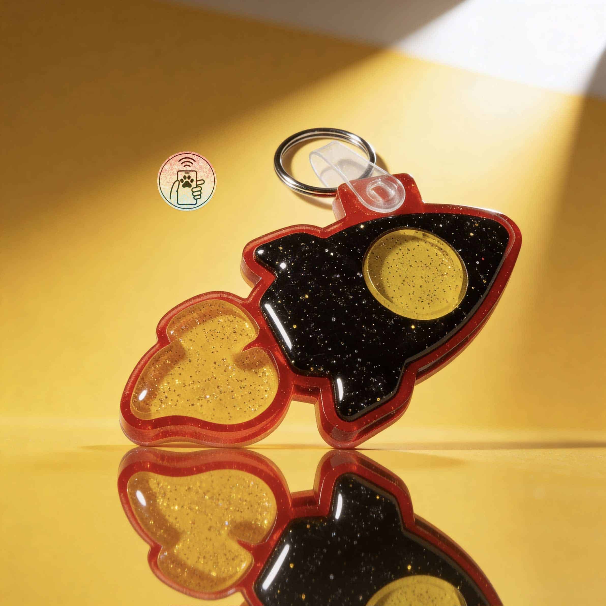 NFC pet ID tag shaped like a rocket with yellow glitter, designed for dogs and cats. Durable acrylic.