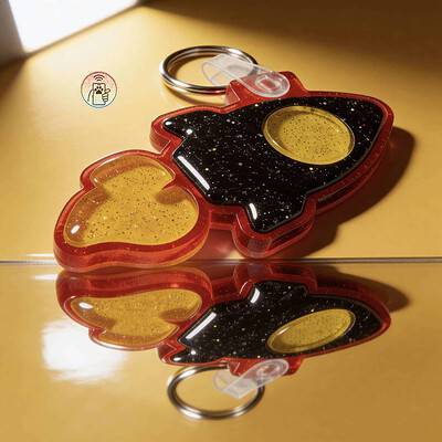 Designer acrylic NFC pet ID tag shaped like a rocket for dogs and cats, with reflective surface.
