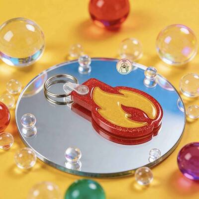 Bright red and yellow fire-shaped pet ID tag with keyring for dogs and cats — Shiloh's House smart NFC pet tag with free companion Lohji app.