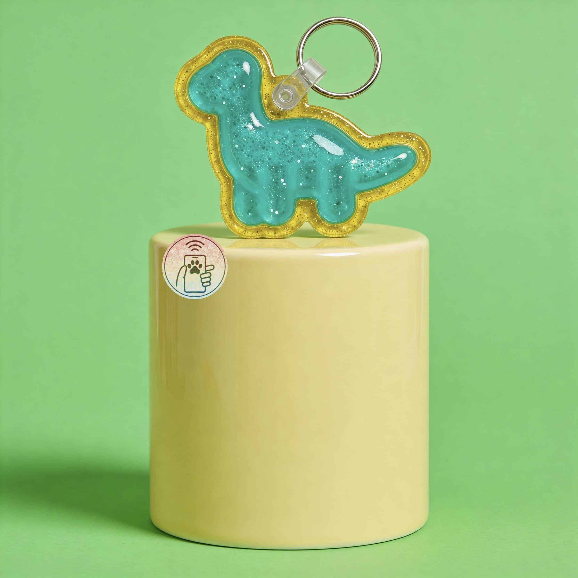 NFC pet ID tag shaped like a dinosaur with glitter, attached to a keyring. Perfect for dogs and cats.