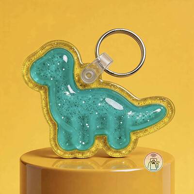 NFC pet ID tag shaped like a dinosaur in turquoise with glitter, attached to a keyring. Perfect for.