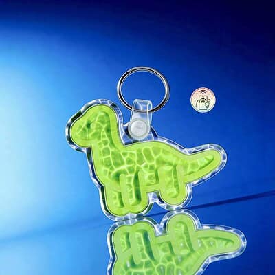 NFC pet ID tag in dinosaur shape with keyring, designed for dogs and cats' identification.